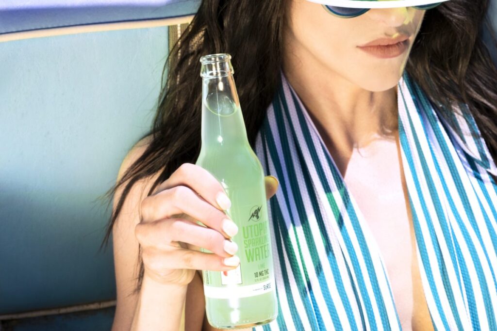 woman holding bottle of Utopia drink