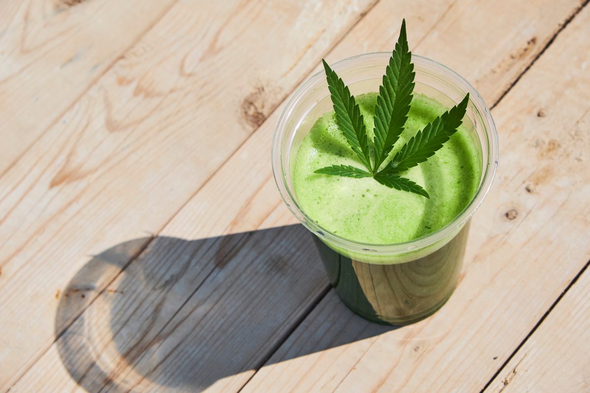 green smoothie with cannabis leaf in it