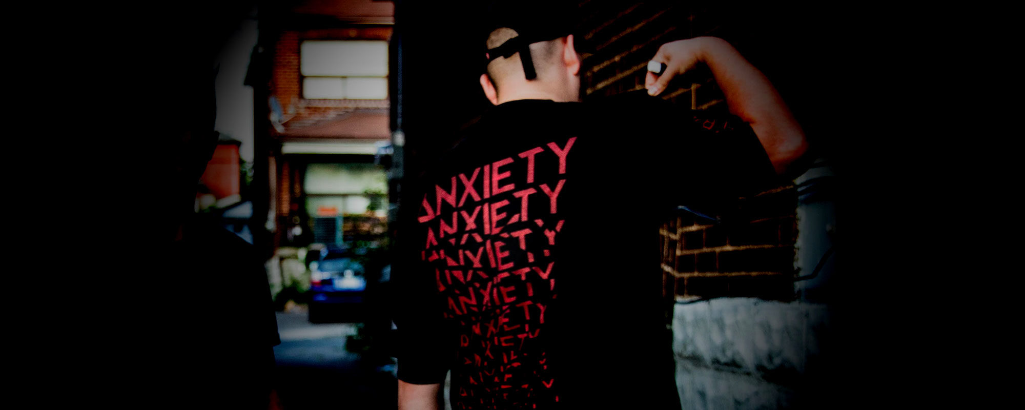 Person wearing Anxiety t shirt in urban dark environment.