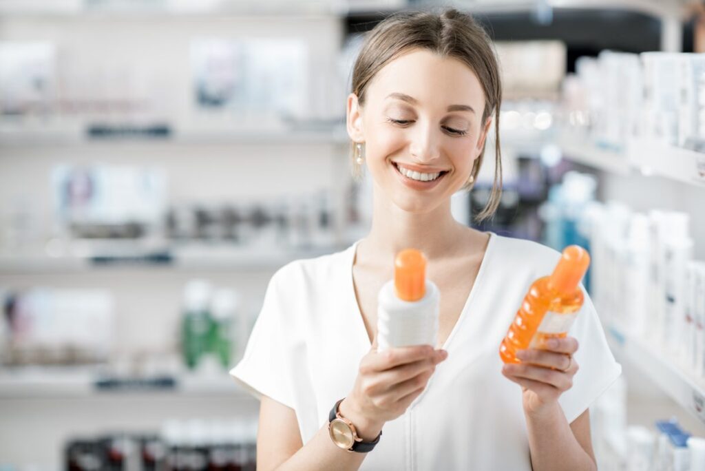 smiling woman holding beauty products on market aisle