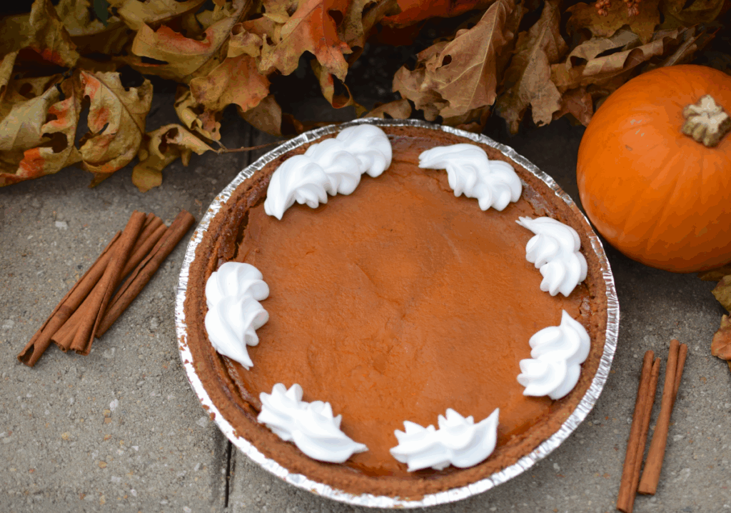 pumpkin pie displayed in front of pumpkin