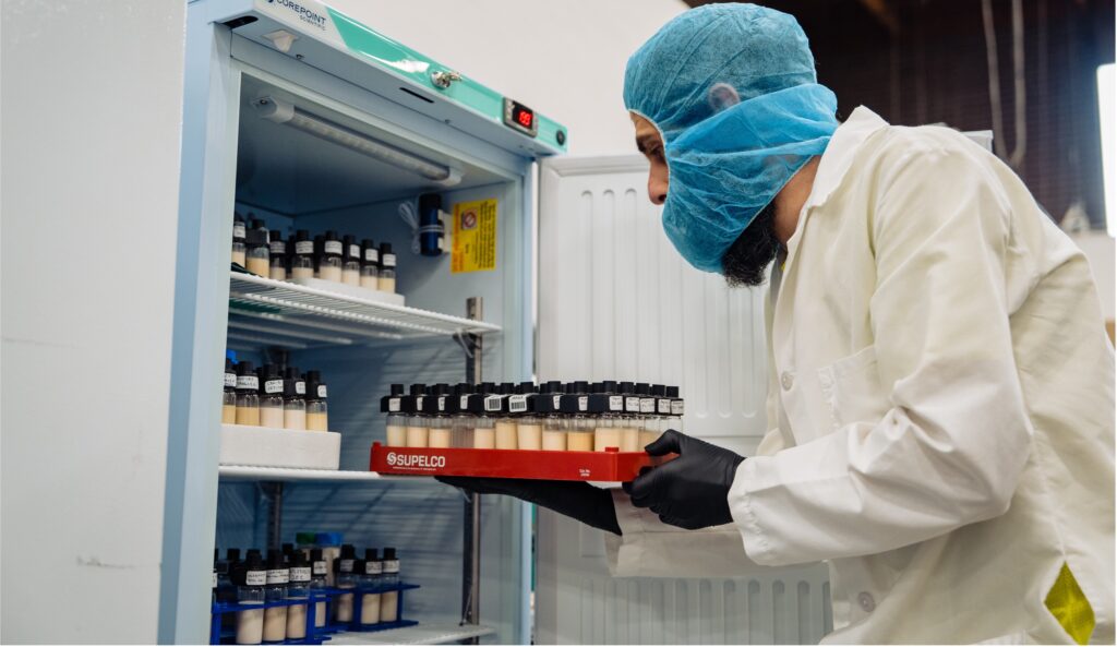 test lab tech putting samples in fridge for stability testing