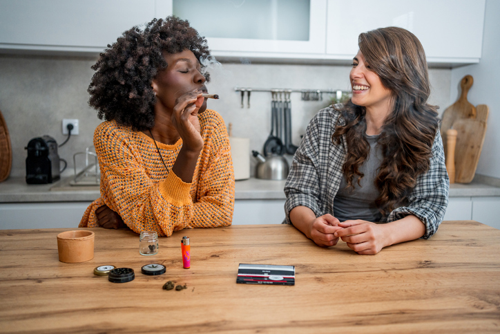 entourage effect women smoking cannabis in a kitchen