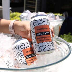 Mad Tasty cans held above bowl of ice.